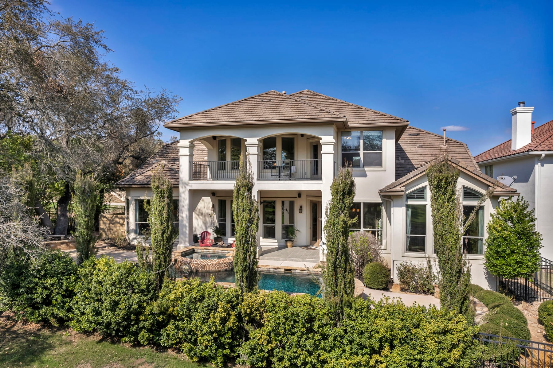 Upscale Central Texas home exterior with mature landscaping
