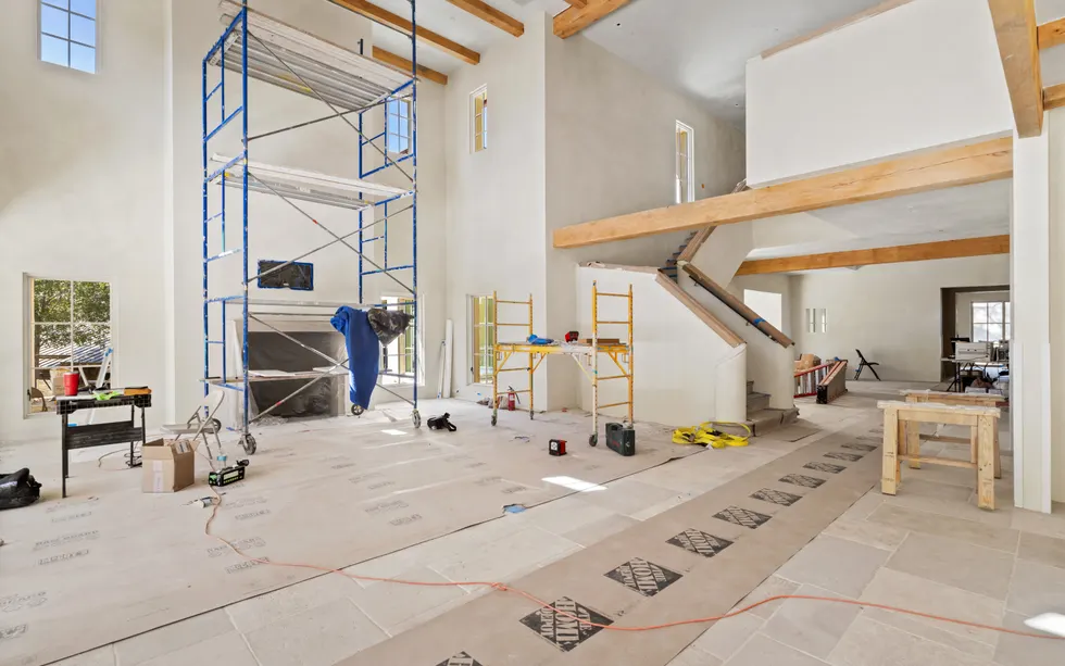Large new construction living area with finish work underway