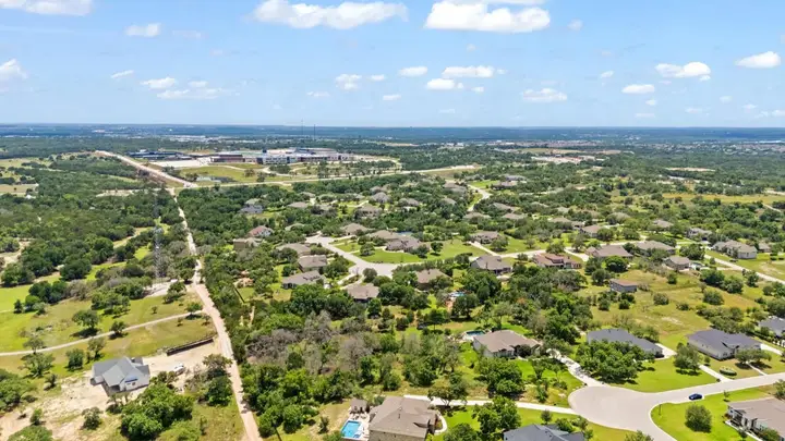 Wide aerial view of communities and open land north of Austin