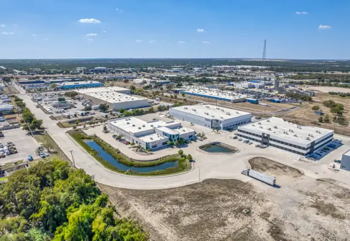 Aerial view of a Round Rock employment corridor with commercial buildings and neighborhood access