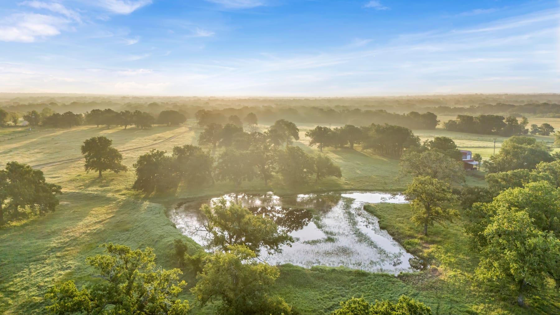 Morning light over pasture, ponds, and rural land near Granger