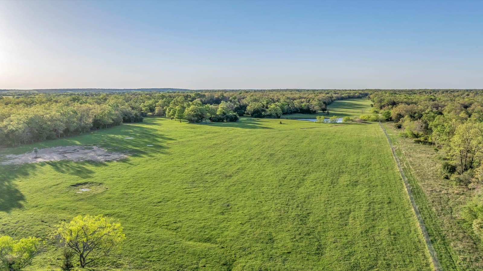 High drone view of open land and Hill Country edges near Liberty Hill
