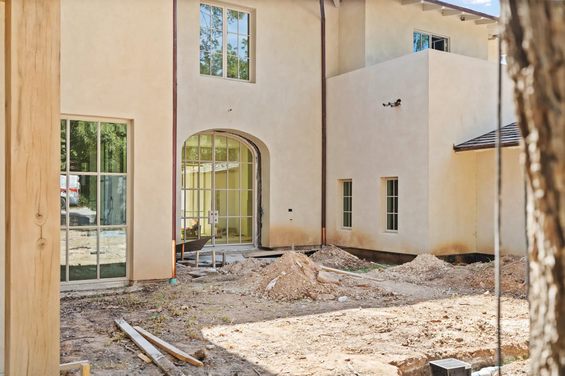 Central Texas new construction home exterior courtyard with site work in progress