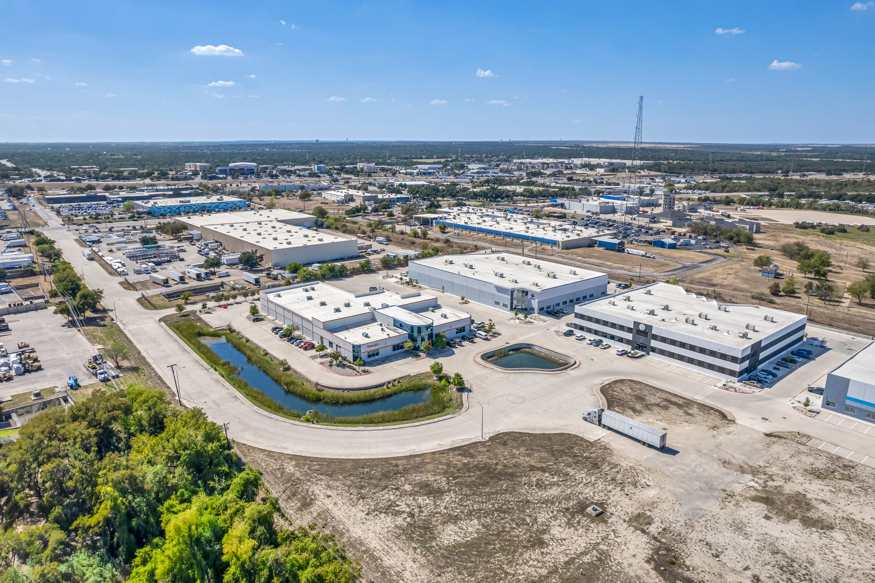 Aerial view of a Round Rock employment corridor with commercial buildings and neighborhood access