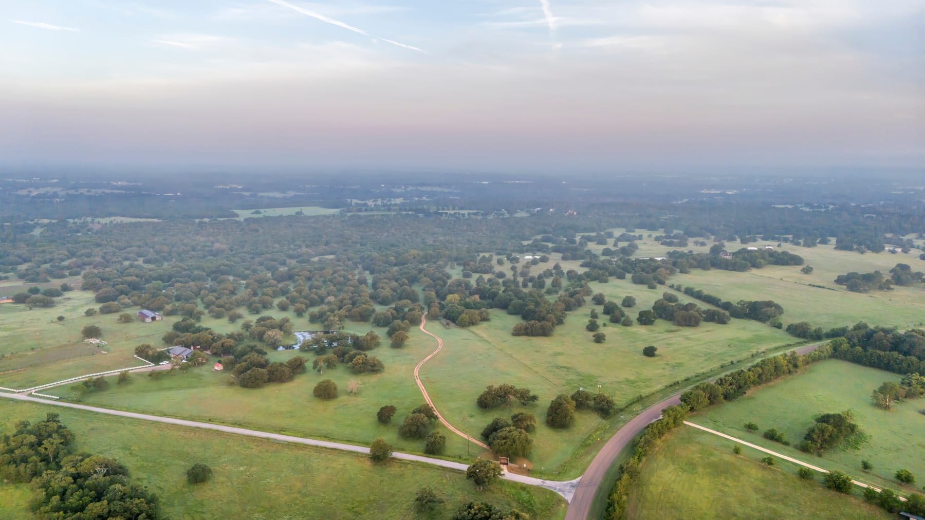 Open rural pasture and tree-lined acreage near Thrall in east Williamson County